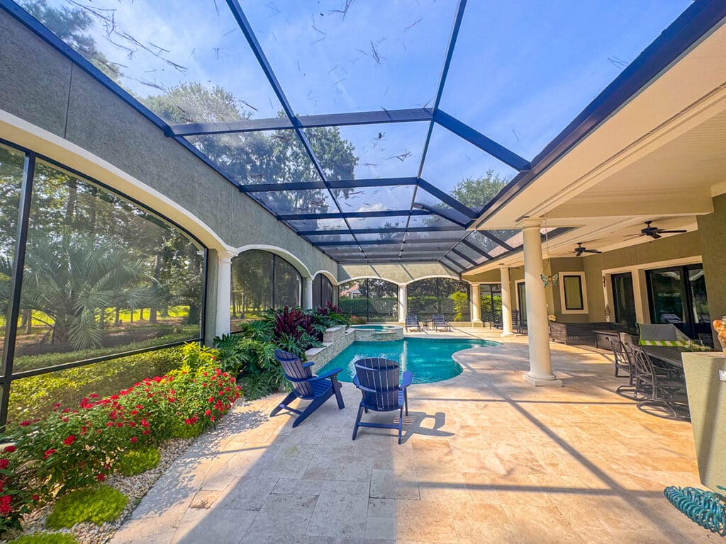 Covered patio with lounge chairs and pool view