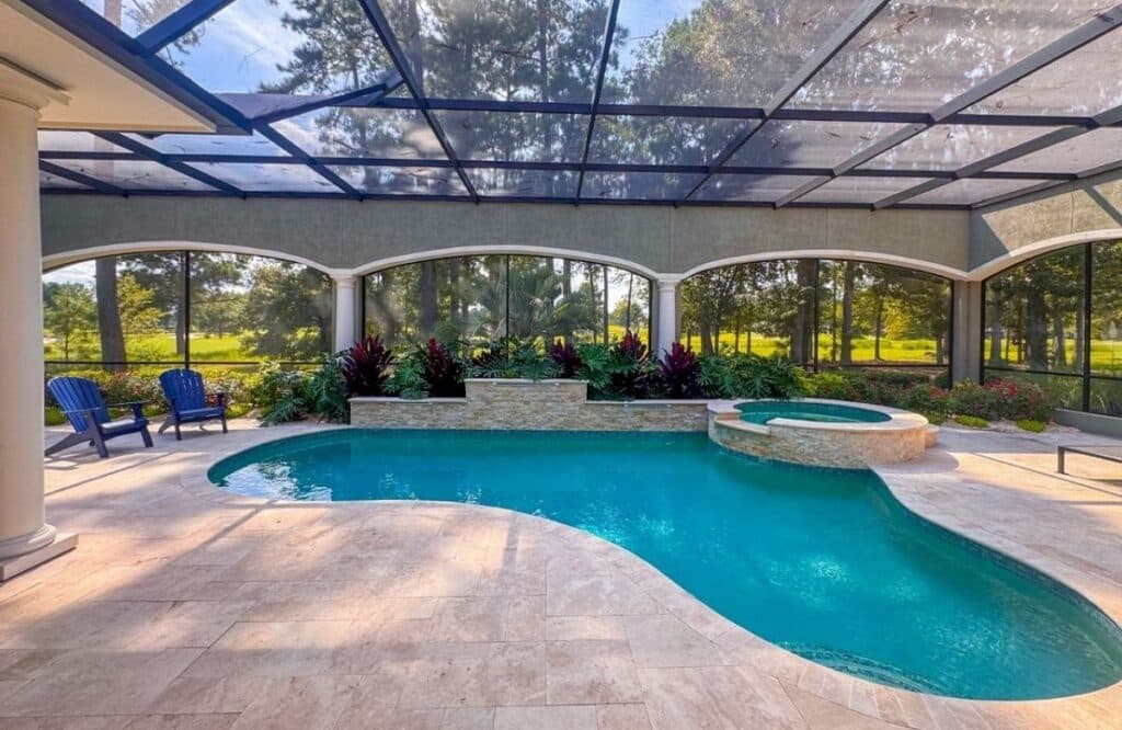 Covered patio and pool area inside screened enclosure